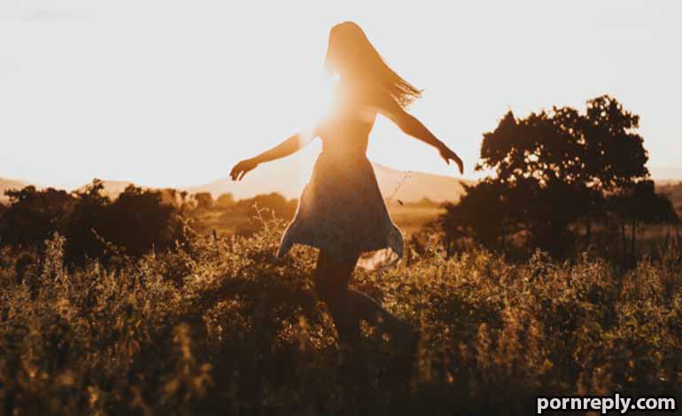 Adult Sex: Healthy Relationship Tips for Better Communication Silhouetted woman dancing in a sunlit field at sunset.